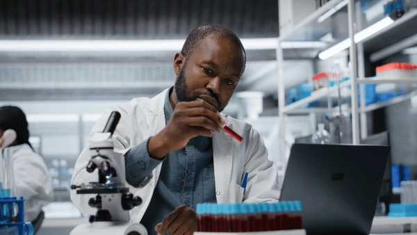 African female laboratory scientist examining blood sample