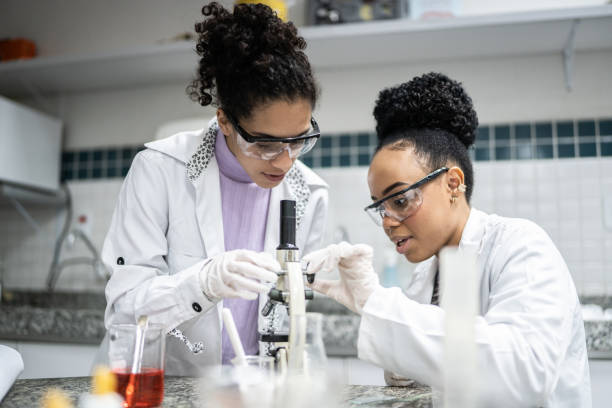 Nigerian medical laboratory scientist working with microscope
